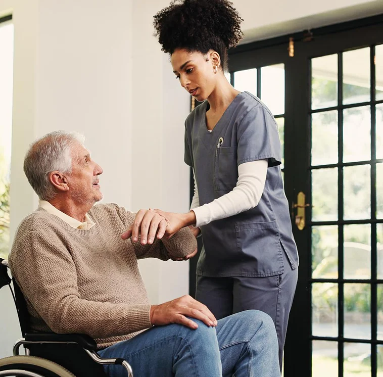 Caregiver assisting senior man in wheelchair