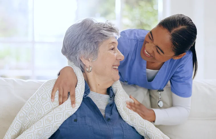 Caregiver comforting senior woman